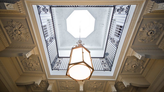 Decorative cornice around a light hanging from the ceiling